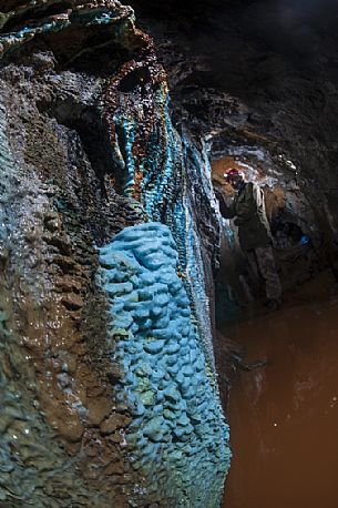 Abandoned copper mine, the water carries with it the mineral that is colored with the contact with the water itself creating the natural sculptures. Zatta mountain, Graveglia valley, Liguria, Italy