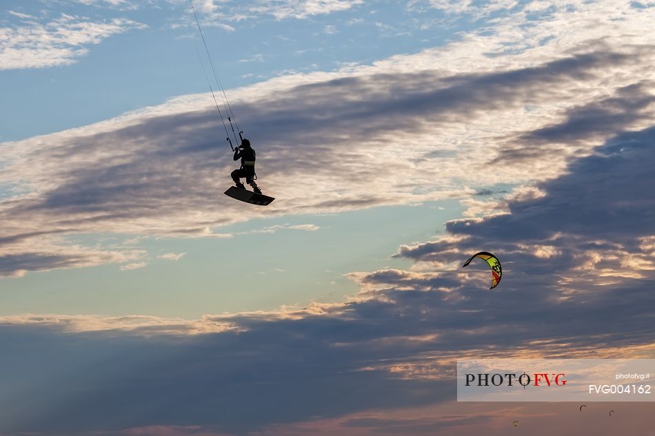 Kitesurfer and kites in the sky of Grado