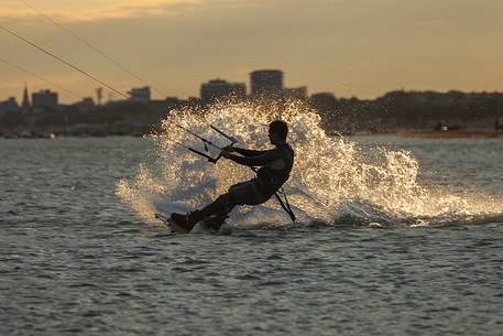 Kitesurfing running fast in the lagoon of Grado