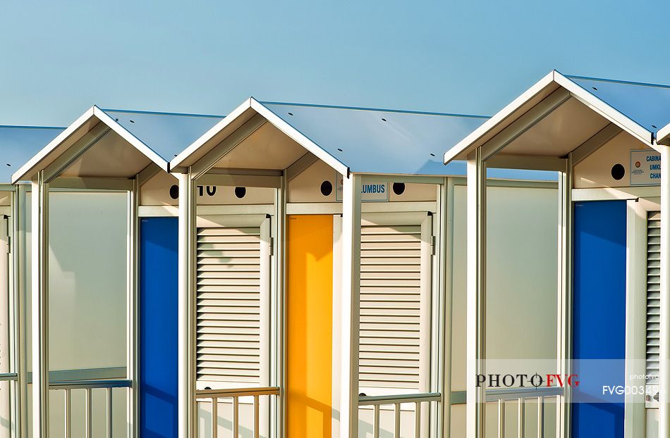 Colorful beach huts on the beach of Lignano Sabbiadoro, famous turistic destination in the Adriatic coast, Friuli Venezia Giulia, Italy