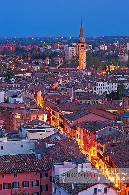 Pordenone, Corso Vittorio Emanuele II street illuminated by the lights of evening, in the background the bell tower of San Marco, Friuli Venezia Giulia, Italy, Europe