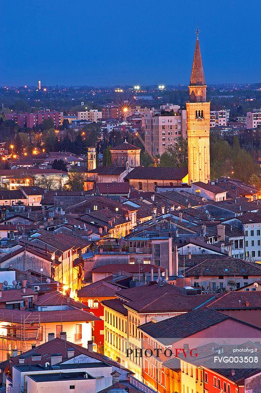 Pordenone, Corso Vittorio Emanuele II street illuminated by the lights of evening, in the background the bell tower of San Marco, Friuli Venezia Giulia, Italy, Europe