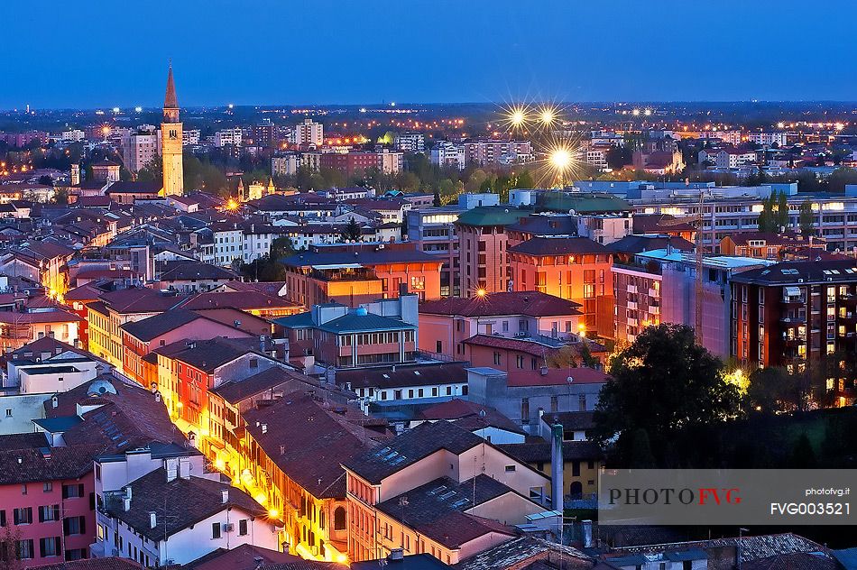 Pordenone, Corso Vittorio Emanuele II street illuminated by the lights of evening, in the background the bell tower of San Marco, Friuli Venezia Giulia, Italy, Europe