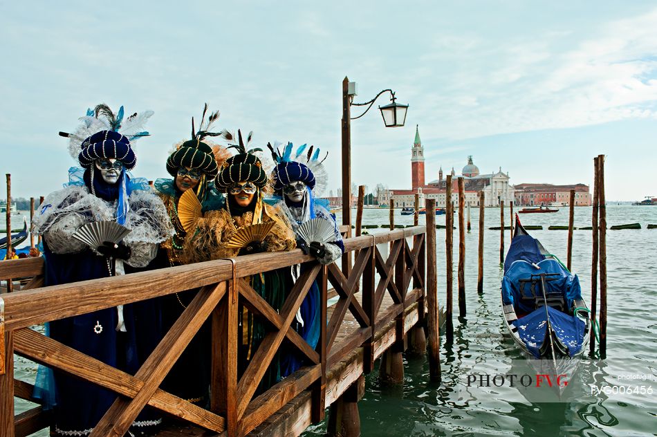 Carnival masks in Venice. In the background the island of San Giorgio Maggiore, Venice, Italy, Europe