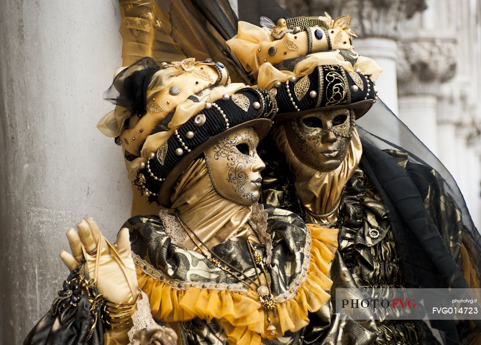 Couple in beautiful costumes during the carnival in Venice.