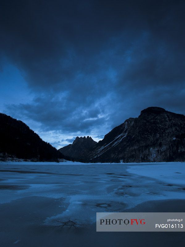 The frozen Predil lake in an ancient glacial basin near Tarvisio, Friuli Venezia Giulia, Italy, Europe
