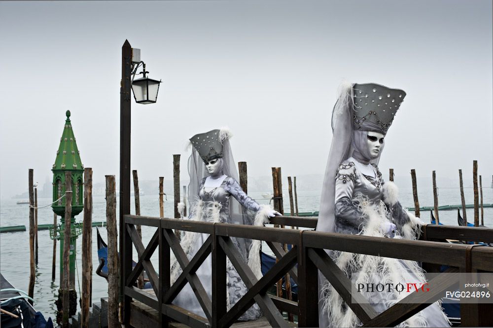 Elegant women with carnival dress in Venice. Italy.