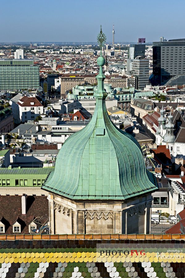 The north bell tower of the saint Stephen cathedral in Vienna, in the background a view of the city. Vienna. Austria