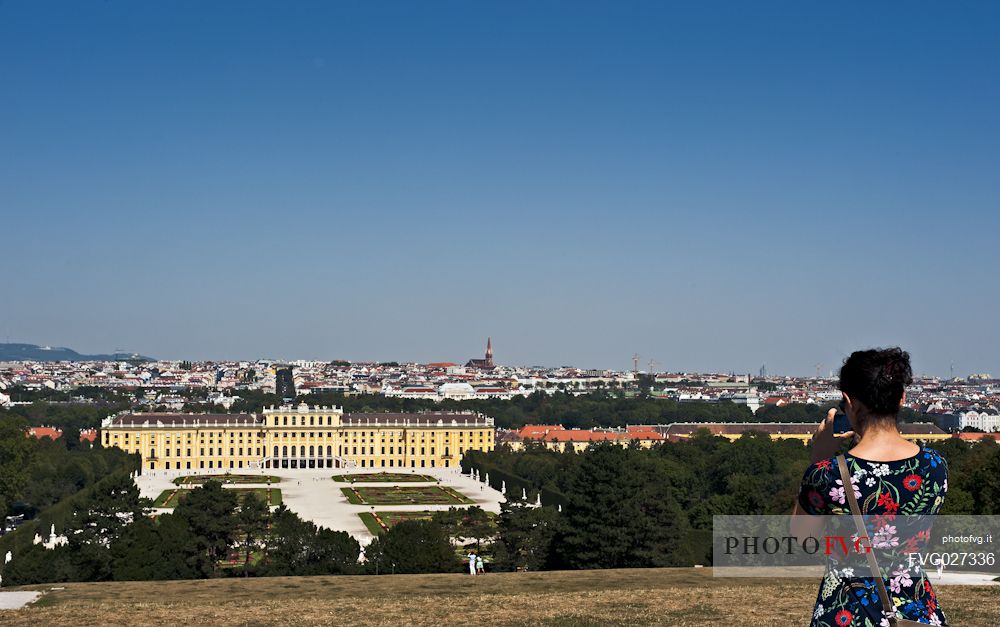 A girl photographs the Schnbrunn Palace in Vienna. It is an imperial summer residence and  a baroque palace, one of the most important architectural, cultural, and historical monuments in Austria.