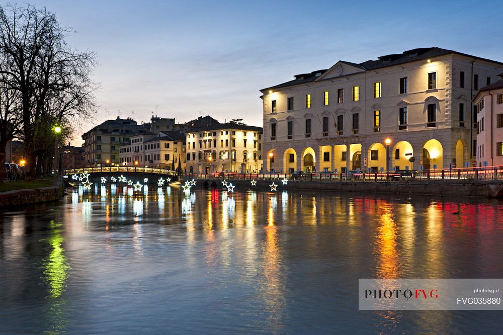 The Christmas lights are reflected on the river Sile in Treviso city, Veneto, Italy, Europe