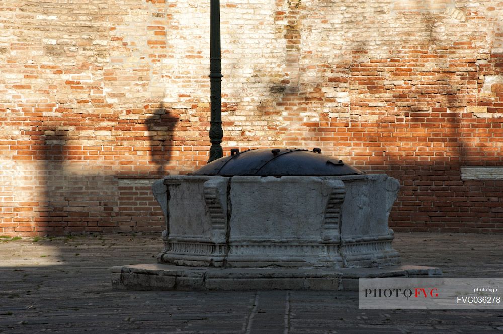 Ancient Venetian stone well in the S. Agnese field in the Dorsoduro district of Venice, Italy, Europe