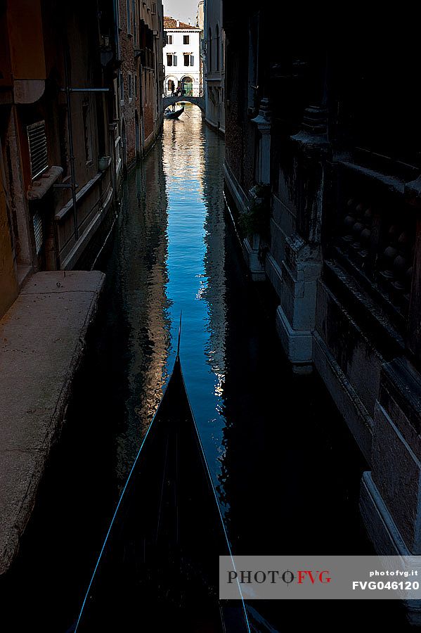 A gondola sails through the narrow canals of Venice, Italy, Europe