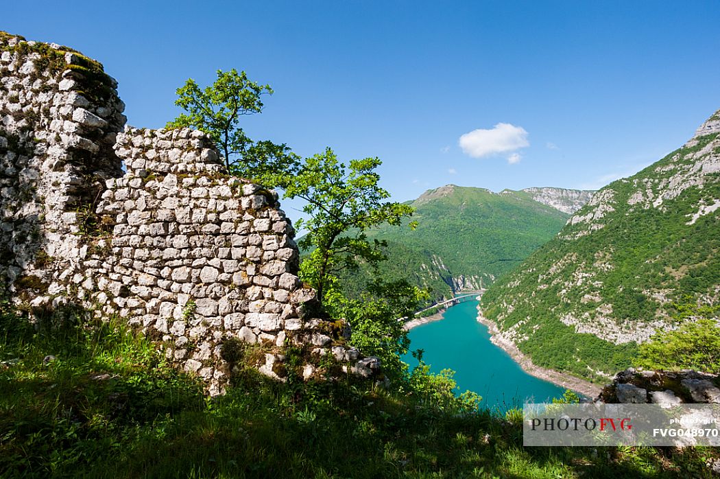 The artificial lake of Ravedis in the territory of Montereale Valcellina in the province of Pordenone and the remains of the ancient castle.  In the background, Mount Pala D'Altei. Italy