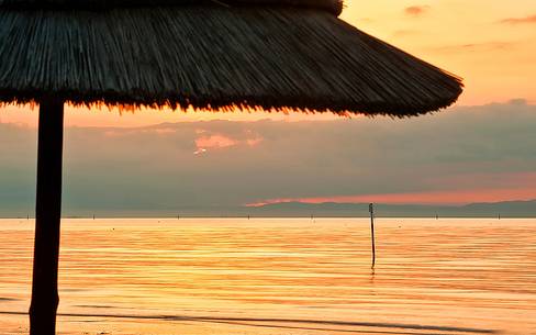 Lignano Sabbiadoro beach at sunset, Adriatic sea, Friuli Venezia Giulia, Italy, Europe Lignano Sabbiadoro beach at sunset, Adriatic sea, Friuli Venezia Giulia, Italy, Europe