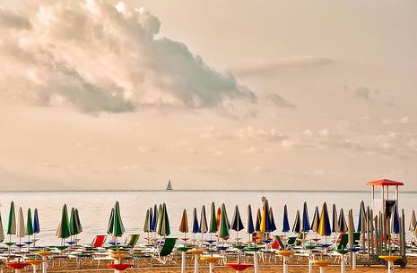 Umbrellas on the beach of the popular tourist destination of Lignano Sabbiadoro, Friuli Venezia Giulia, Italy, Europe