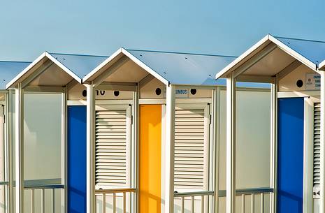 Colorful beach huts on the beach of Lignano Sabbiadoro, famous turistic destination in the Adriatic coast, Friuli Venezia Giulia, Italy