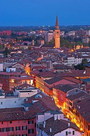 Pordenone, Corso Vittorio Emanuele II street illuminated by the lights of evening, in the background the bell tower of San Marco, Friuli Venezia Giulia, Italy, Europe