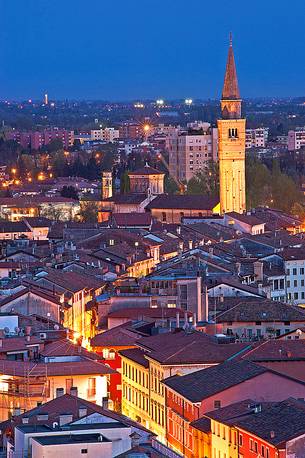 Pordenone, Corso Vittorio Emanuele II street illuminated by the lights of evening, in the background the bell tower of San Marco, Friuli Venezia Giulia, Italy, Europe