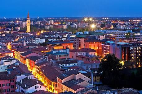 Pordenone, Corso Vittorio Emanuele II street illuminated by the lights of evening, in the background the bell tower of San Marco, Friuli Venezia Giulia, Italy, Europe