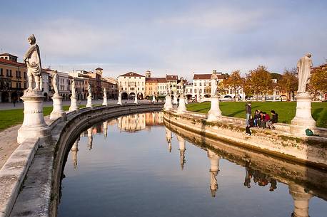 Prato della Valle is a square elliptical  in Padova, Italy. It is the largest square in Italy and one of the largest in Europe. Today, the square is a large space with a green island at the center, l'Isola Memmia, surrounded by a small canal bordered by two rings of statue, Italy, Europe