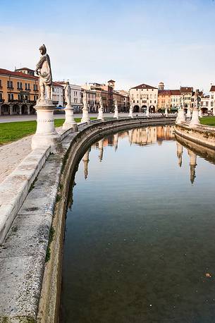 Prato della Valle is a square elliptical  in Padova, Italy. It is the largest square in Italy and one of the largest in Europe. Today, the square is a large space with a green island at the center, l'Isola Memmia, surrounded by a small canal bordered by two rings of statue, Italy, Europe