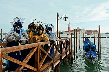 Carnival masks in Venice. In the background the island of San Giorgio Maggiore, Venice, Italy, Europe