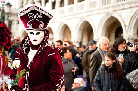 Tourists and carnival mask in San Marco square, Venice, Italy, Europe
