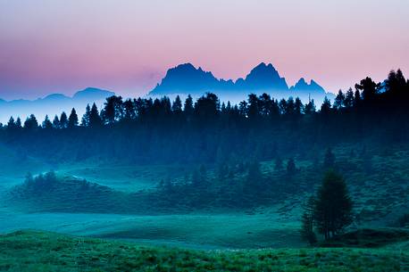 The dawn paints the sky above the Creton of Clap Grande mount in Carnia, Sauris, Friuli Venezia Giulia, Italy, Europe