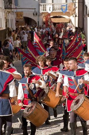 Flag-waving and drummers along the historical street of the village in a historical reconstruction of Valvasone, Friuli Venezia Giulia, Italy
