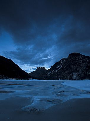 The frozen Predil lake in an ancient glacial basin near Tarvisio, Friuli Venezia Giulia, Italy, Europe
