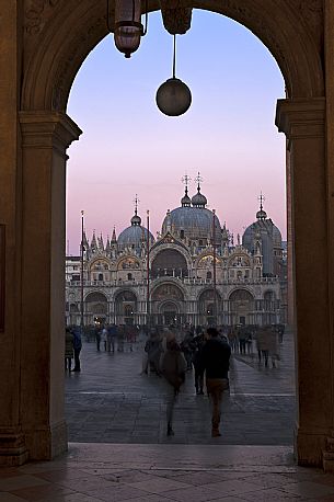 Tourists in Saint Mark Square admire the cathedral at sunset, Venice. Italy Tourists in Saint Mark Square admire the cathedral at sunset, Venice. Italy