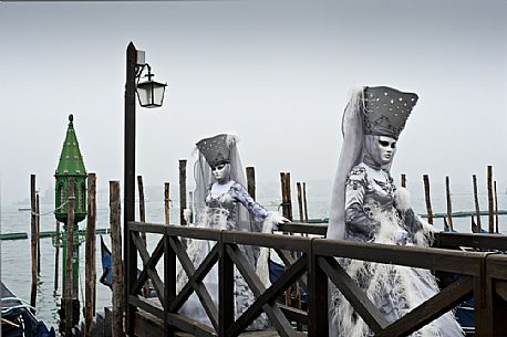 Elegant women with carnival dress in Venice. Italy.