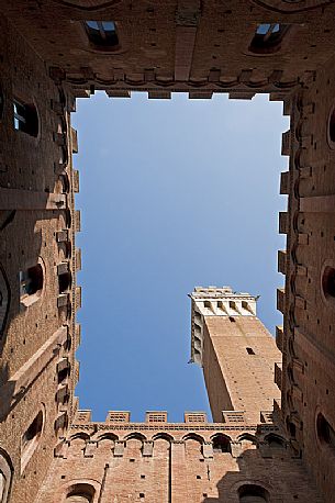 Inner Courtyard of Palazzo Pubblico with Torre del Mangia in Siena, Tuscany, Italy.