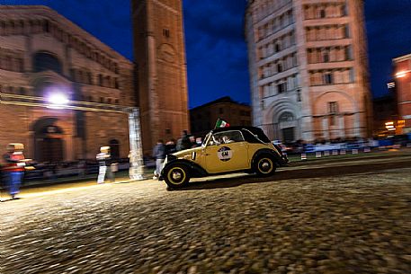 Vintage car race in the Piazza Duomo square with Baptistery and Cathedral, Parma, Italy Vintage car race in the Piazza Duomo square with Baptistery and Cathedral, Parma, Italy