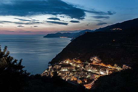 Riomaggiore illuminated at twilight, Cinque Terre, Ligury, Italy