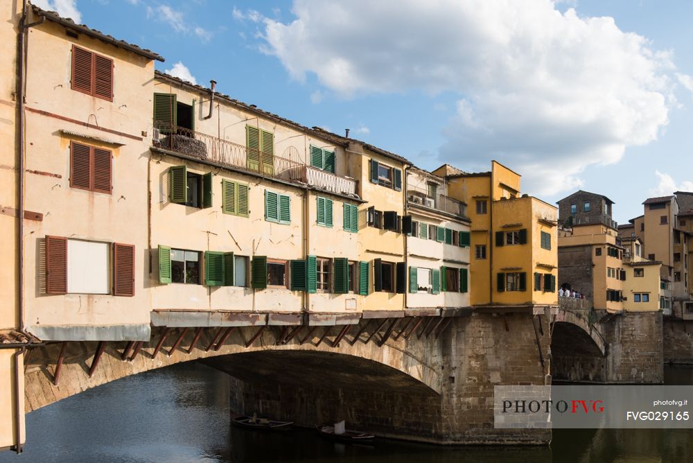 Ponte Vecchio in daylight and the colorful external facades of the jewelry shops on Arno river, Florence, Tuscany, Italy