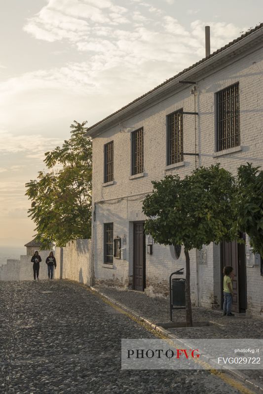 A street of the Albaicin or Albayzn arab quarter in Granada during sunset, Spain
