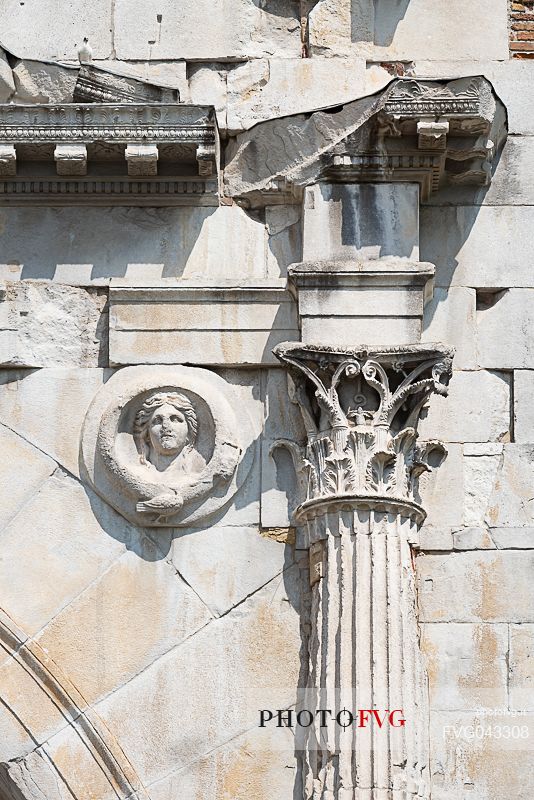 Detail with Jupiter shield and capital facing Rome.of Arch of Augustus in Rimini, Emilia Romagna, Italy, Europe