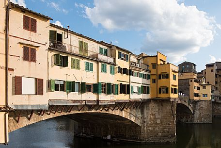 Ponte Vecchio in daylight and the colorful external facades of the jewelry shops on Arno river, Florence, Tuscany, Italy