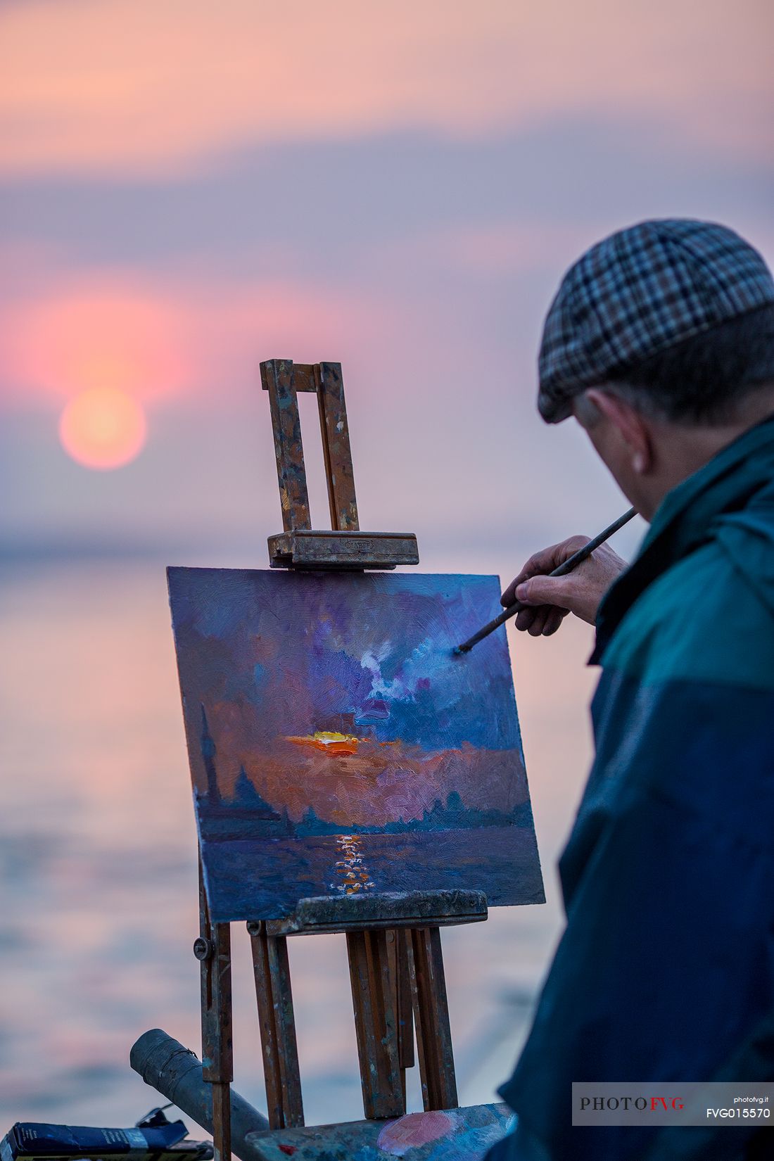 The Painter colors his picture on the Canal Grande in Venice during a sunset