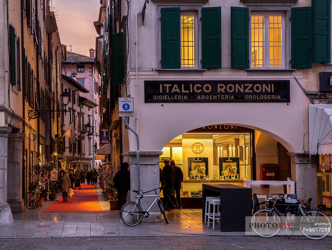 Via Mercato Vecchio lights in the evening , in the center of Udine
