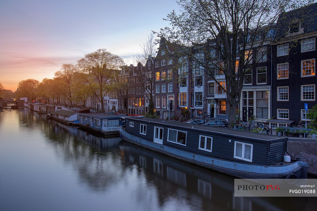 The canal houses along the banks of the Prinsengracht , one of the three main canals of Amsterdam