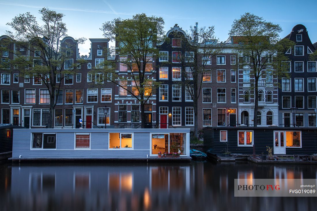 The canal houses along the banks of the Prinsengracht , one of the three main canals of Amsterdam