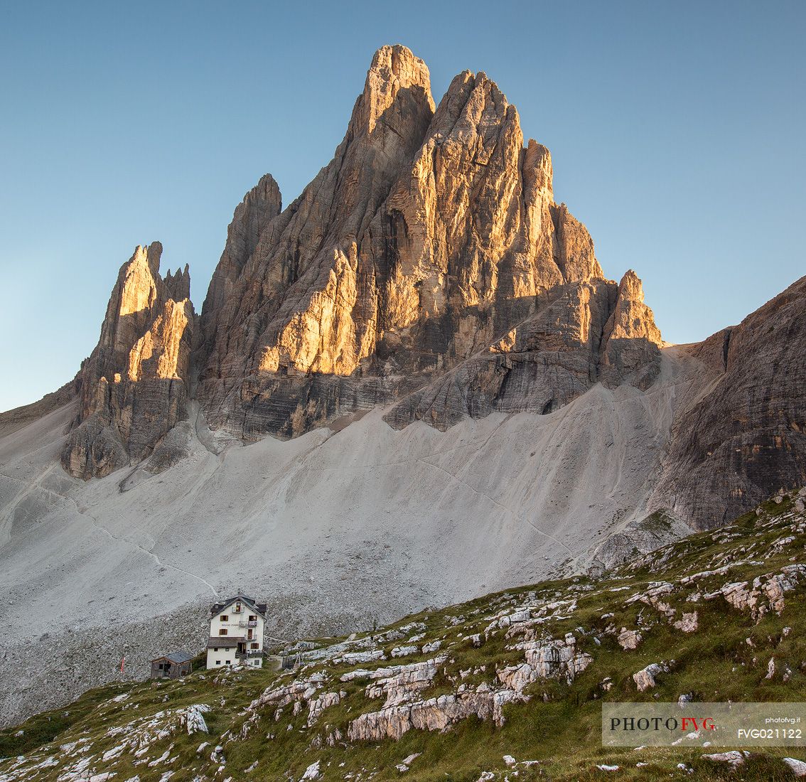 The alpine hut of Zsigmondy - Comici with the Croda dei Toni on background lit by sunset, Sexten dolomites, Tre Cime natural park, Dolomites, South Tyrol, Italy, Europe