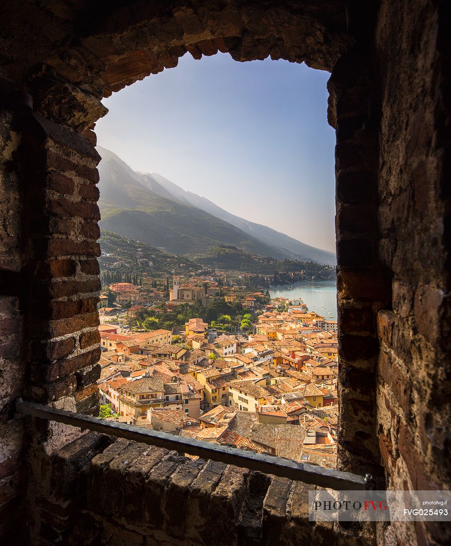 The small medieval village of Malcesine on Garda lake framed by the castle walls of Scaligero, Italy