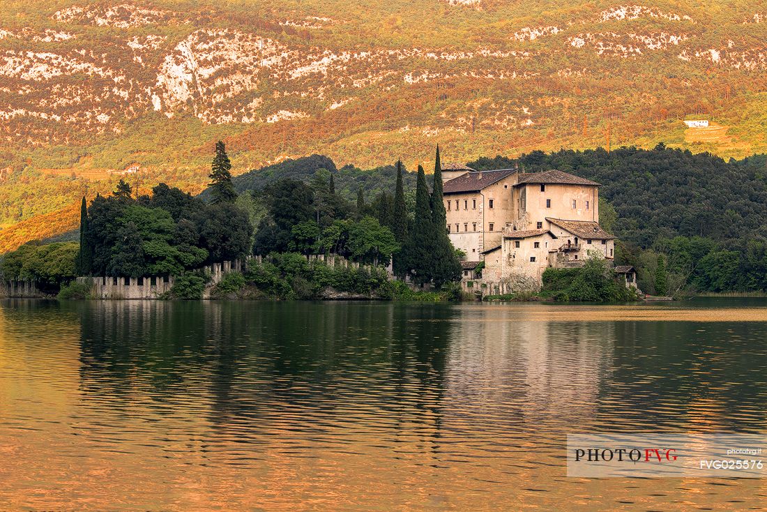 The Toblino Castle reflects on the waters of the homonymous lake, Valley of Lakes, Valle dei Laghi, Trentino, Italy