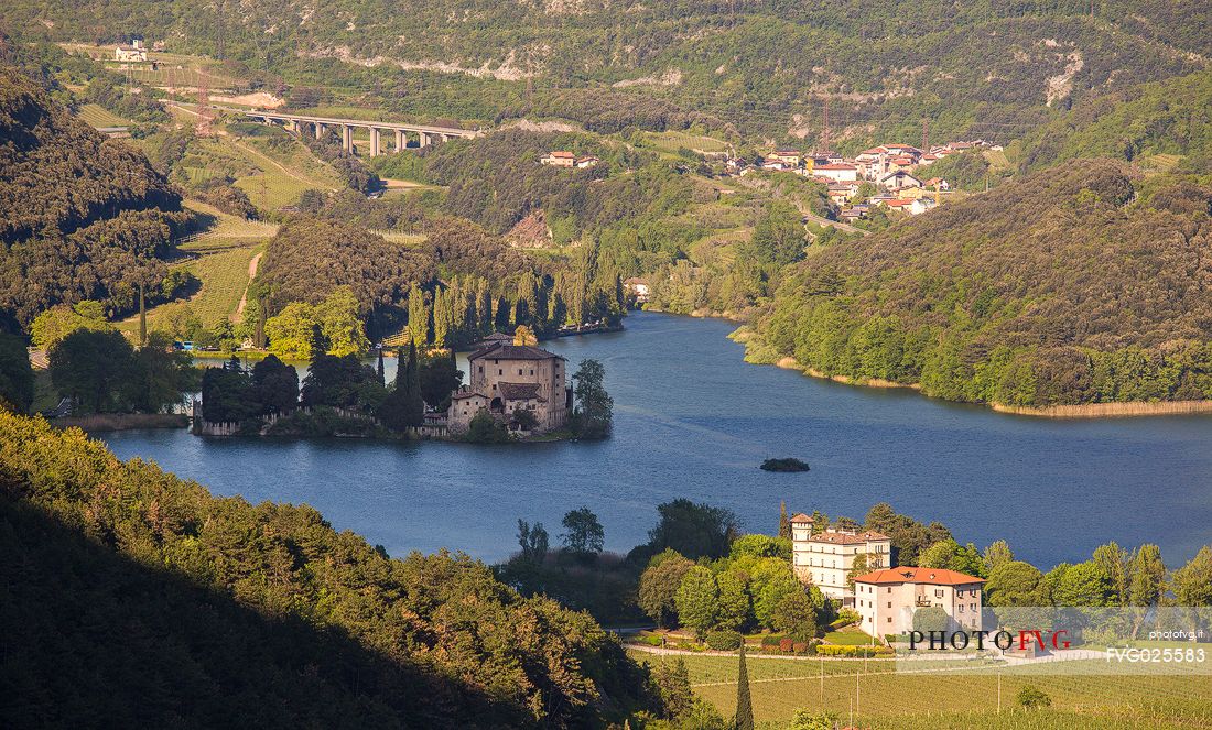 View from above of Toblino Lake with the homonymous castle, in the foreground the historic Toresella farm, Valley of Lakes, Trentino, Italy