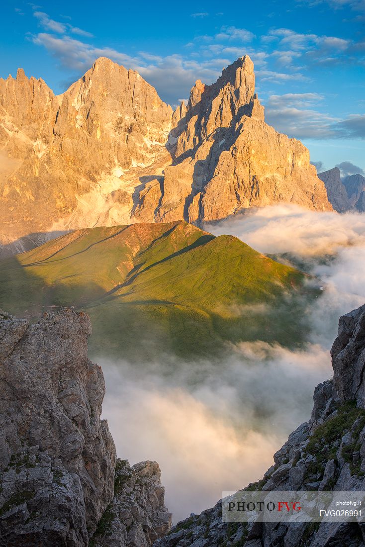 The northern chain of the Pale di San Martino with the Cimon della Pala over a cloud of clouds photographed from the top of the path of Cristo Pensante, Dolomites, San Martino di Castrozza, Italy The northern chain of the Pale di San Martino with the Cimon della Pala over a cloud of clouds photographed from the top of the path of Cristo Pensante, Dolomites, San Martino di Castrozza, Italy