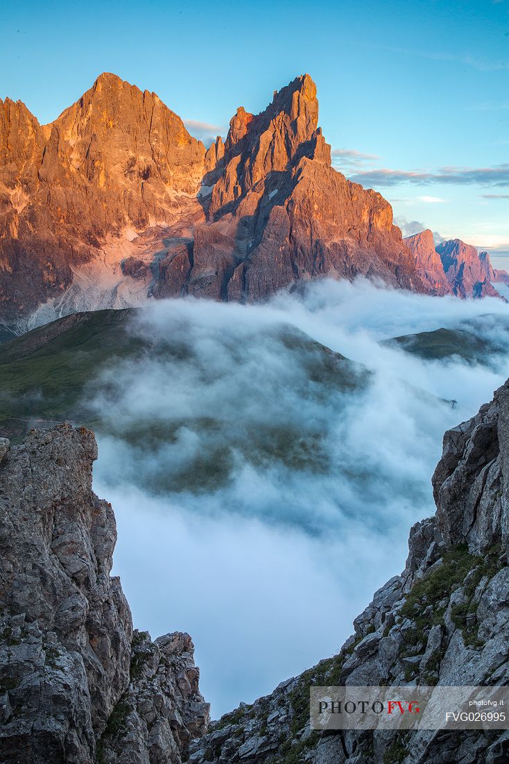 The northern chain of the Pale di San Martino with the Cimon della Pala over a cloud of clouds photographed from the top of the path of Cristo Pensante, Dolomites, San Martino di Castrozza, Italy