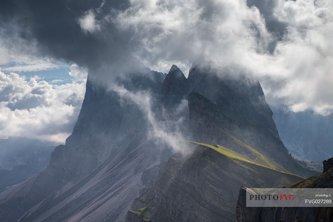 The Odle group wrapped in clouds after thunderstorms photographed from Seceda, Dolomites, Ortisei, Italy